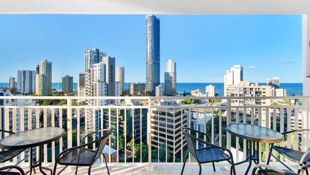 A balcony with a view of a city skyline and the ocean. - Spacious 3 Bedroom Apartment in Surfers Paradise - CoastHM (Surfers Paradise)