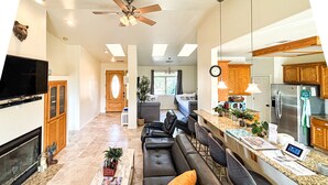 A modern living room with a fireplace, a sofa set, and a coffee table. - Thoughtfully Designed for Accessibility and Family-Friendliness. (Mariposa)