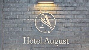 A wall with a logo and the text "Hotel August" indicating the hotel's name. - Hwagok August (Seoul)