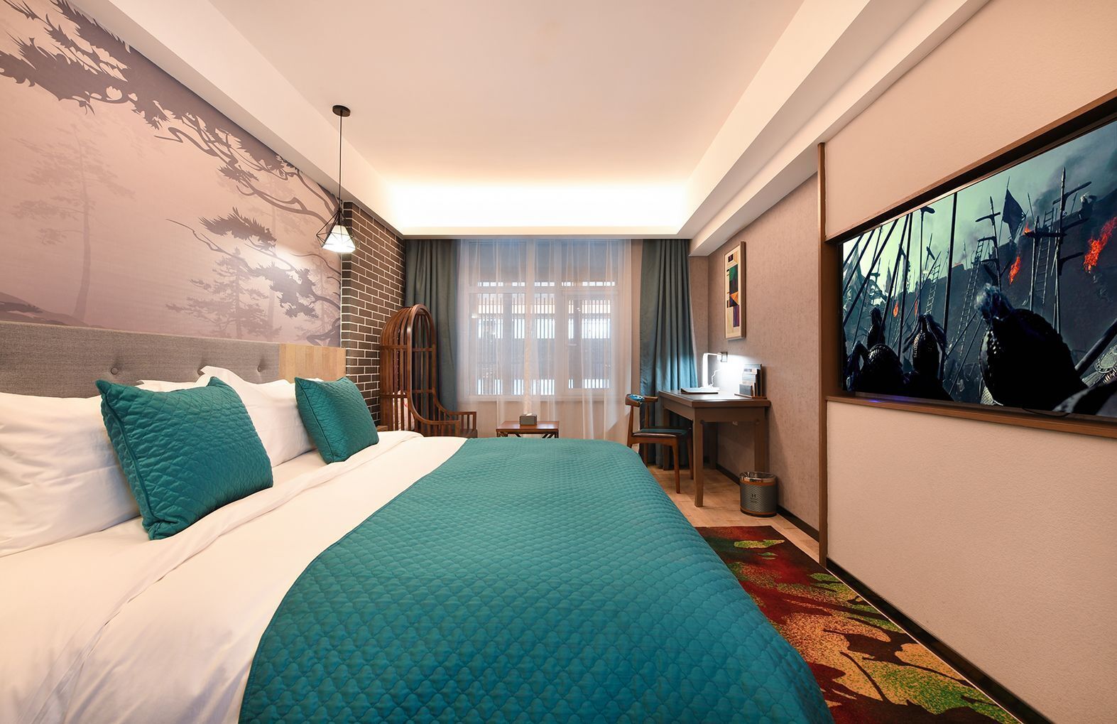 A hotel room with a large bed, a desk, and a painting on the wall.