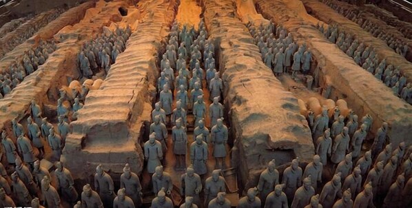 A large number of stone statues arranged in rows.