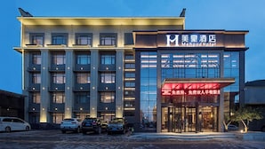 A modern hotel building with a prominent entrance and multiple floors.