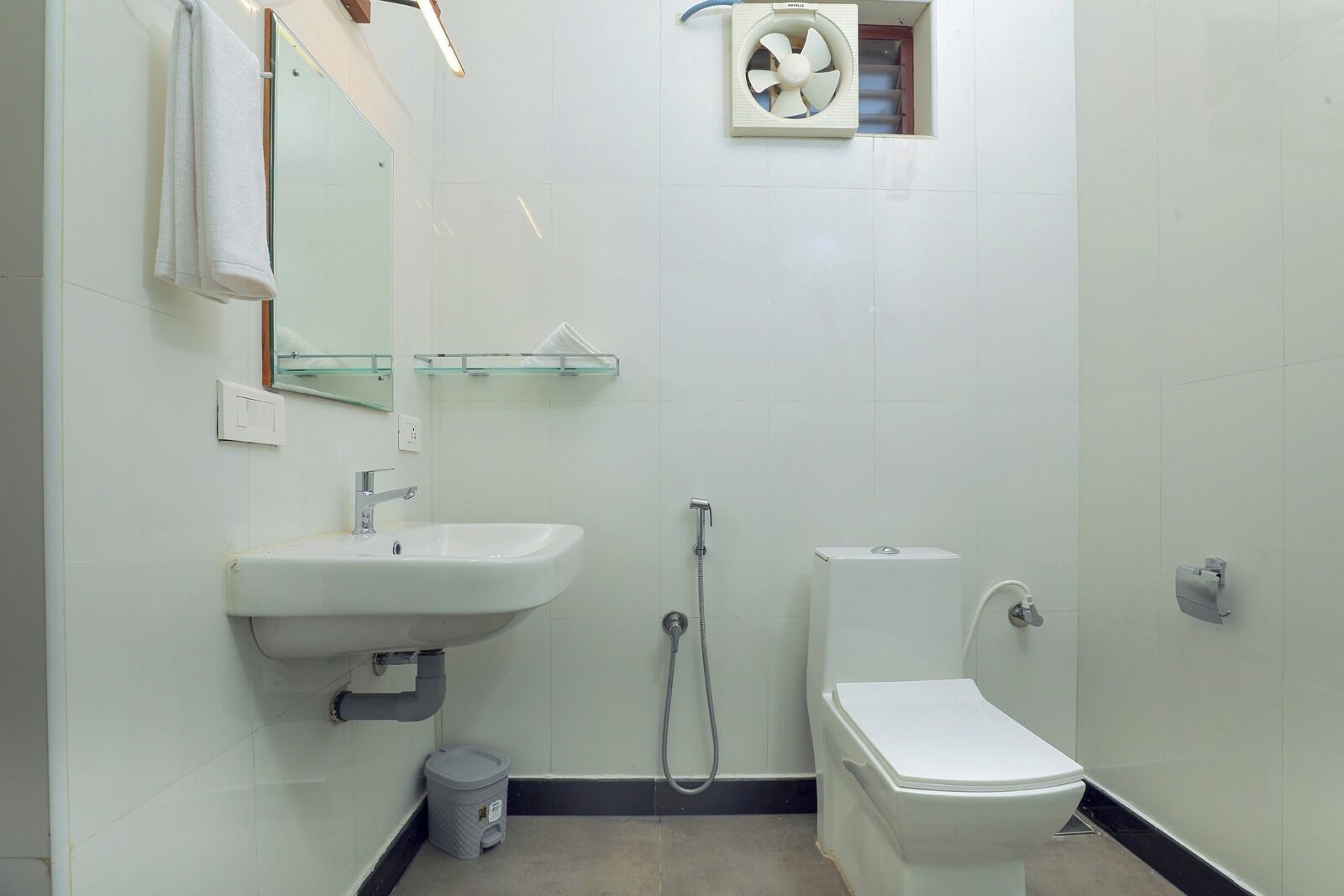 A bathroom with a sink, toilet, and shower.
