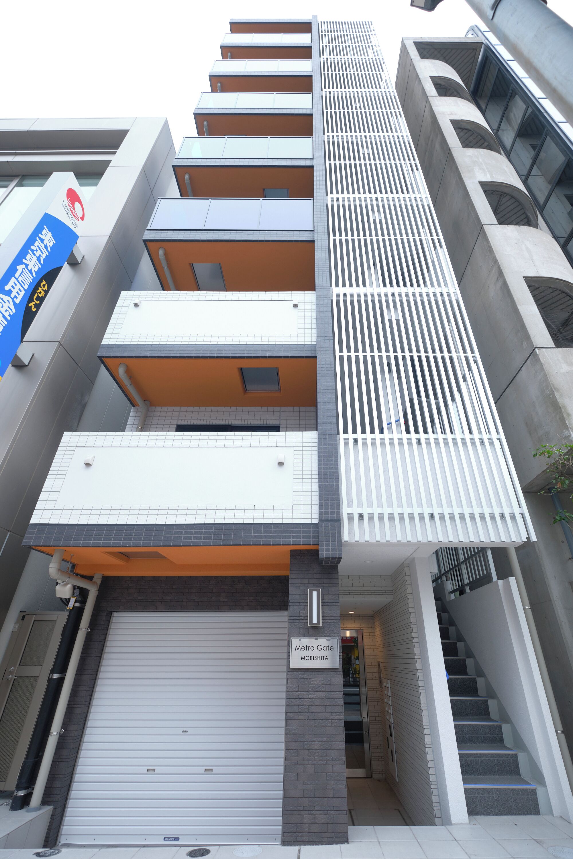 A modern building with a Metro Gate entrance, multiple balconies, and a stairway.