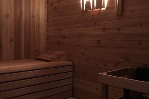 A wooden sauna with benches and a small table. - House With a Private Swimming Pool and Sauna (Swinoujscie)
