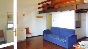A compact living space with a bunk bed, a sofa, a desk, and a chair. - Residence Pratone, Garda (Garda)