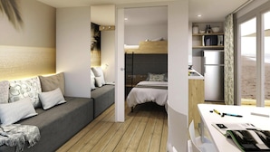 A compact hotel room with a sofa, a bunk bed, a kitchenette, and a large window. - Mobile Home for dog Owners in Caorle (Caorle)