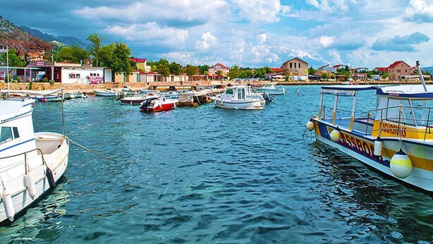 A marina with various boats docked, surrounded by buildings and a mountainous backdrop. - Holiday Home in Starigrad With Sea Views (Starigrad)