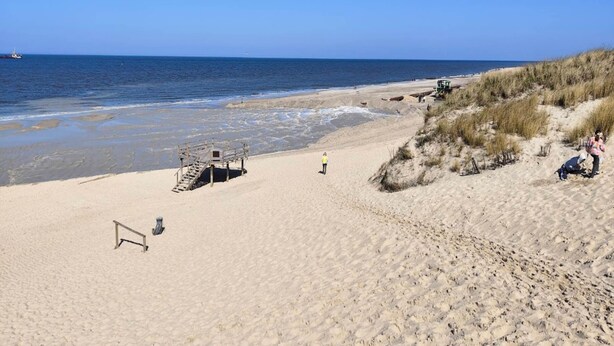 A beach with a wooden structure, a lifeguard tower, and a sandy path leading to the water. - Appartement in Westerland auf Sylt (Sylt)