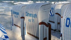 Rows of white beach chairs with blue text on the backrests, labeled "Dinerpark." - Ferienwohnung im Dunenpark Binz (Binz)