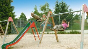 A playground with a slide and swings. - Ferienpark Tennenbronn (Schramberg)