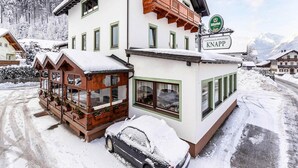 A two-story building with a sign for 'GASTHAUS PENSION KNAPPI'.