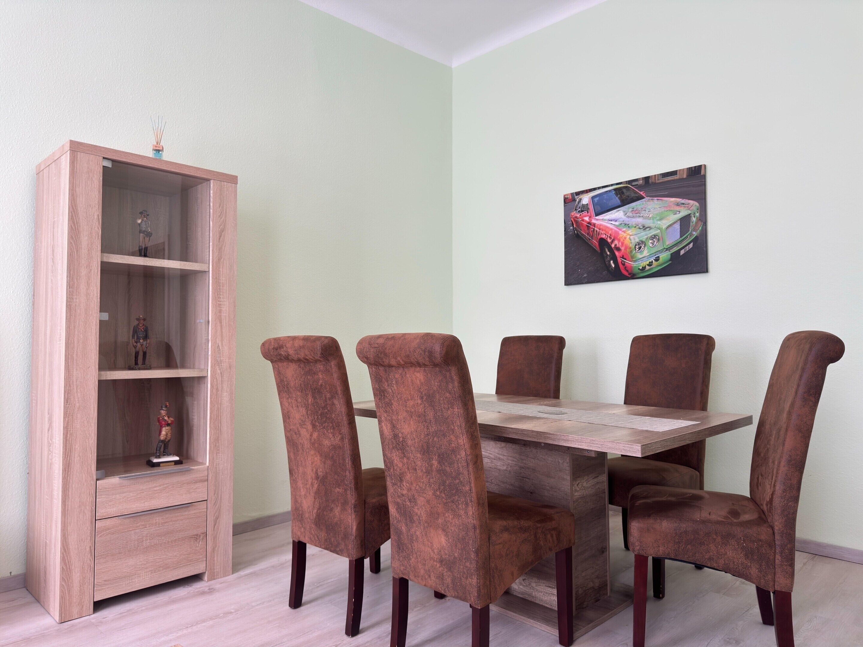 A dining area with a wooden table and six chairs.