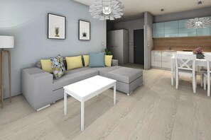 A modern living room with a grey sectional sofa, a white coffee table, and a dining area with a white table and chairs. - Apartment in Grzybowo Near Seaside Beach (Kołobrzeg)