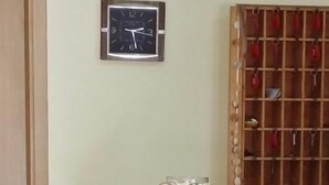 A kitchen with a clock, a cabinet, and a spice rack. - Baia dello Stretto (Reggio Calabria)