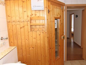 A wooden door with a sauna control panel and a towel rack. - Doppelhaushalfte Strandhaus I in Trassenheide (Trassenheide)
