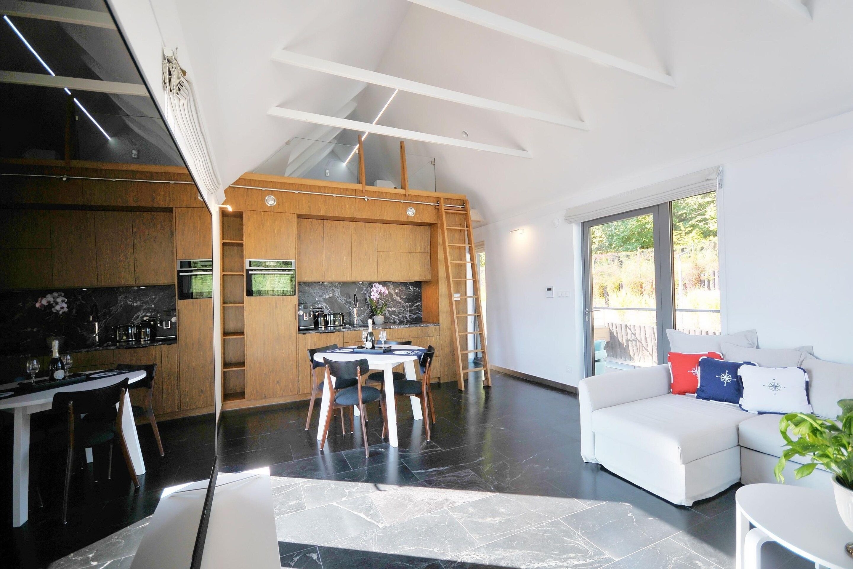 A modern interior with a kitchen, dining area, and living space.