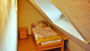 A small bedroom with a sloped ceiling and a skylight. - Holiday Home With Thatched Roof, Rekowo (Bytow)