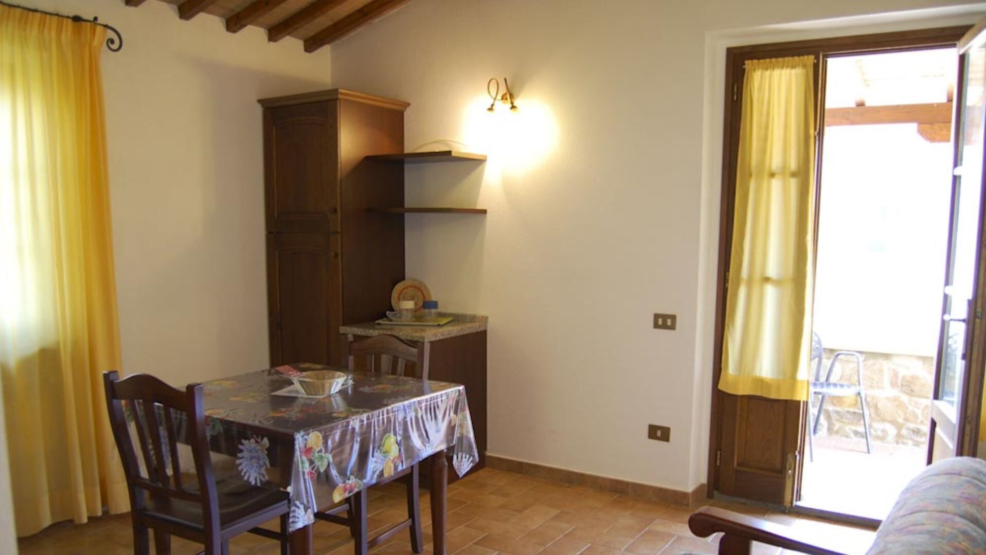 A dining area with a table, chairs, a cabinet, and a small countertop.