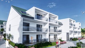 A modern multi-story residential building with balconies, a green roof, and a landscaped garden area. - Holiday Apartment in Grzybowo (Kołobrzeg)