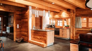 A spacious kitchen with wooden cabinetry, a central island, and modern appliances. - Chalet in Leutasch Near Kreithlift Ski Resort (Leutasch)