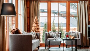A cozy living room with a sofa, a coffee table, and a fireplace. - Chalet in Leutasch Near Kreithlift Ski Resort (Leutasch)