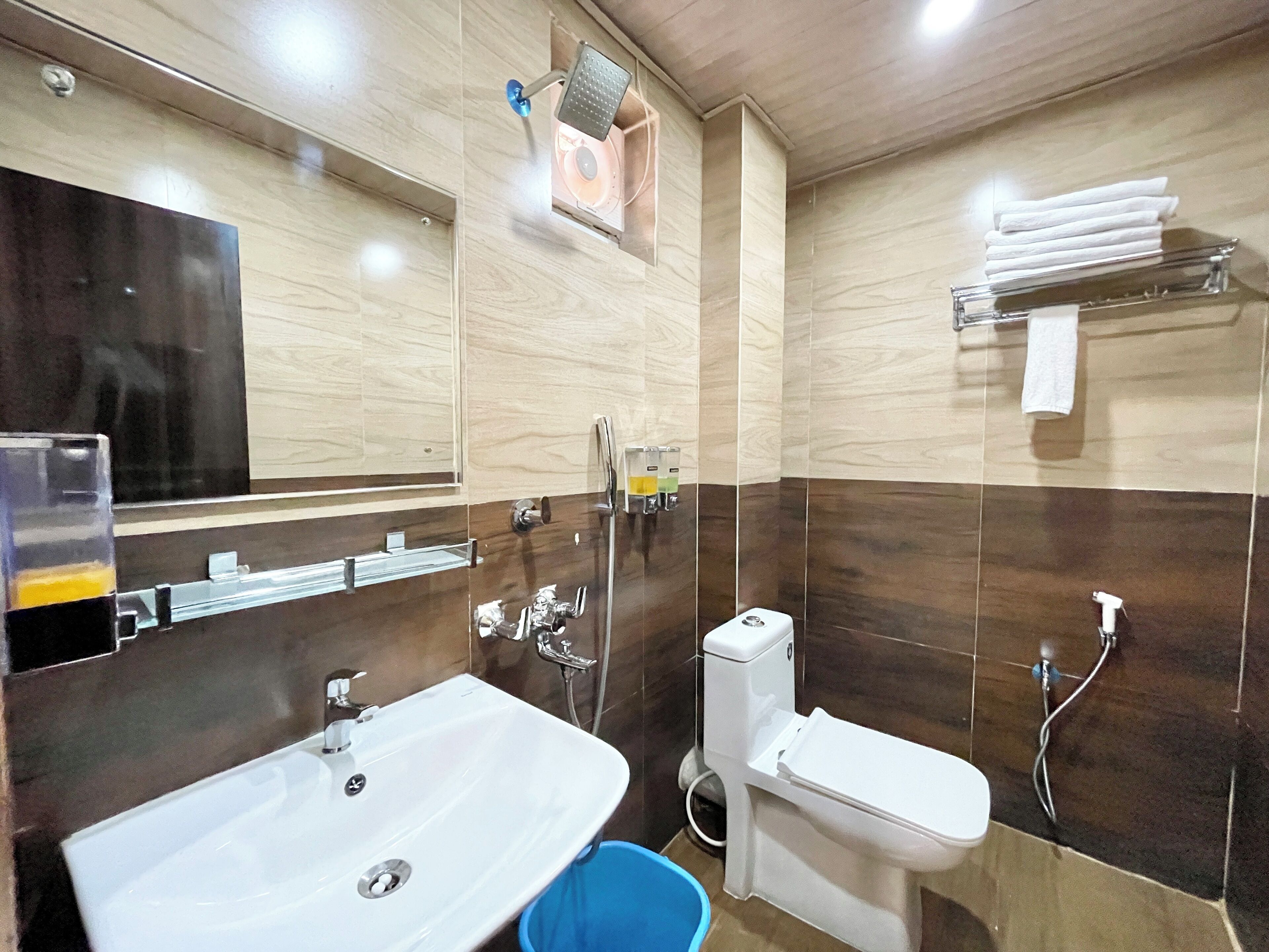 A bathroom with a sink, toilet, and shower.