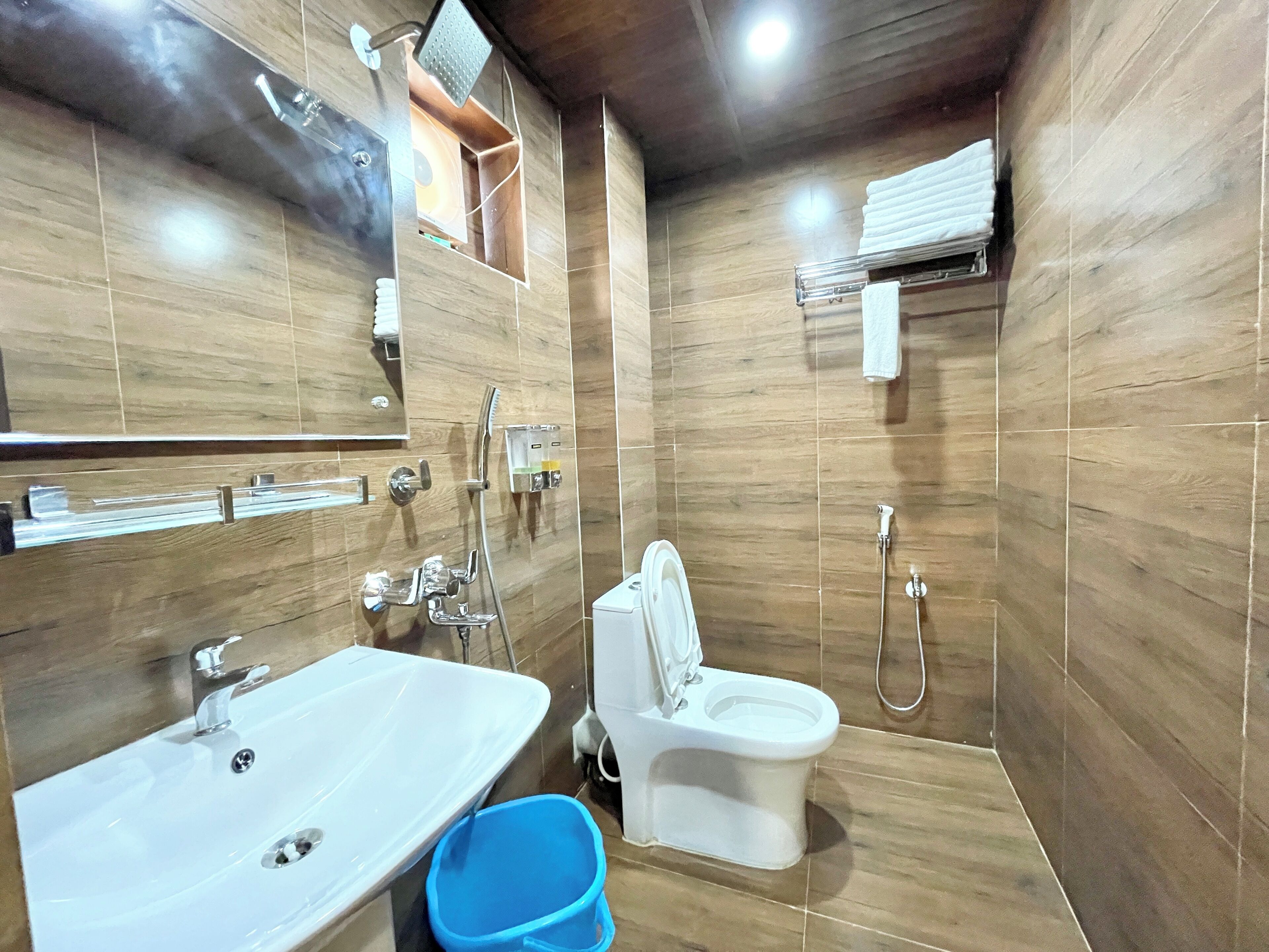 A bathroom with a sink, toilet, and shower.