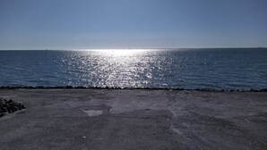 A concrete waterfront with a clear view of the sea and a distant horizon. - Penthouse am Nordstrand auf dem Deich (Nordstrand)