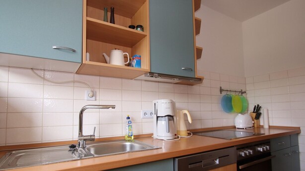 A kitchen with a sink, coffee maker, and dishwasher. - Wohnung am Bocksberg Nahe Skilift (Goslar)
