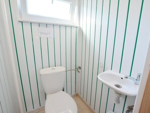 A small bathroom with a toilet and a sink. - Single-story Holiday Home Close to the Beach (gmina Manowo)