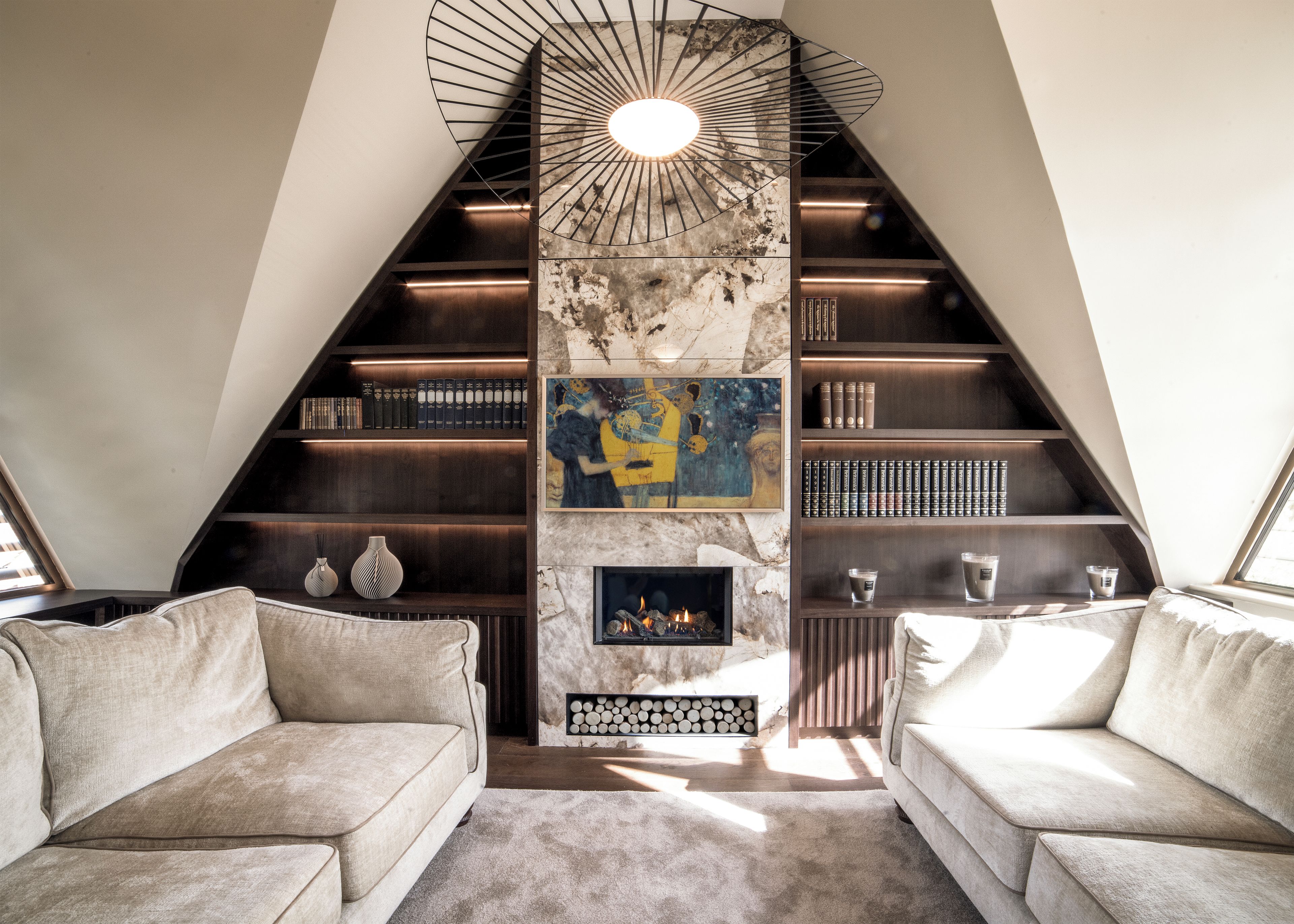 A modern interior with a fireplace, bookshelves, and a unique spiral staircase.