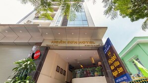The entrance of Nguyen Son Hotel with a clear view of the entrance, a signboard, and a staircase leading to the upper floor. - Mai Villa Ngan Son HN - by BAY LUXURY (Hanoi)