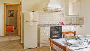 A compact kitchen with a refrigerator, stove, oven, and white cabinets. - Beautiful Apartment in Lamporecchio (Lamporecchio)