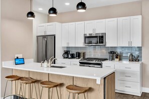 Fridge, microwave, oven, stovetop - Modern 2BR Bywater condo with 2 king beds, pool & gym. Balcony, parking, near French Quarter. (New Orleans)