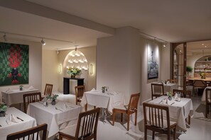 A restaurant with multiple tables and chairs, a central decorative light fixture, and a large painting on the wall. - Casa Foscolo Hotel, Istanbul, a Member of Design Hotels (Istanbul)