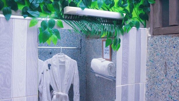A bathroom with a white bathtub, a towel rack, and a mirror. - Pacha Waterfront Nithi (Chuka)
