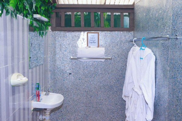 A bathroom with a granite countertop sink, a towel rack, and a framed sign above the sink. - Pacha Waterfront Nithi (Chuka)