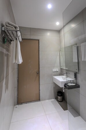 Basic Room | Bathroom | Shower, hair dryer, towels, toilet paper - World Inn (Visakhapatnam)