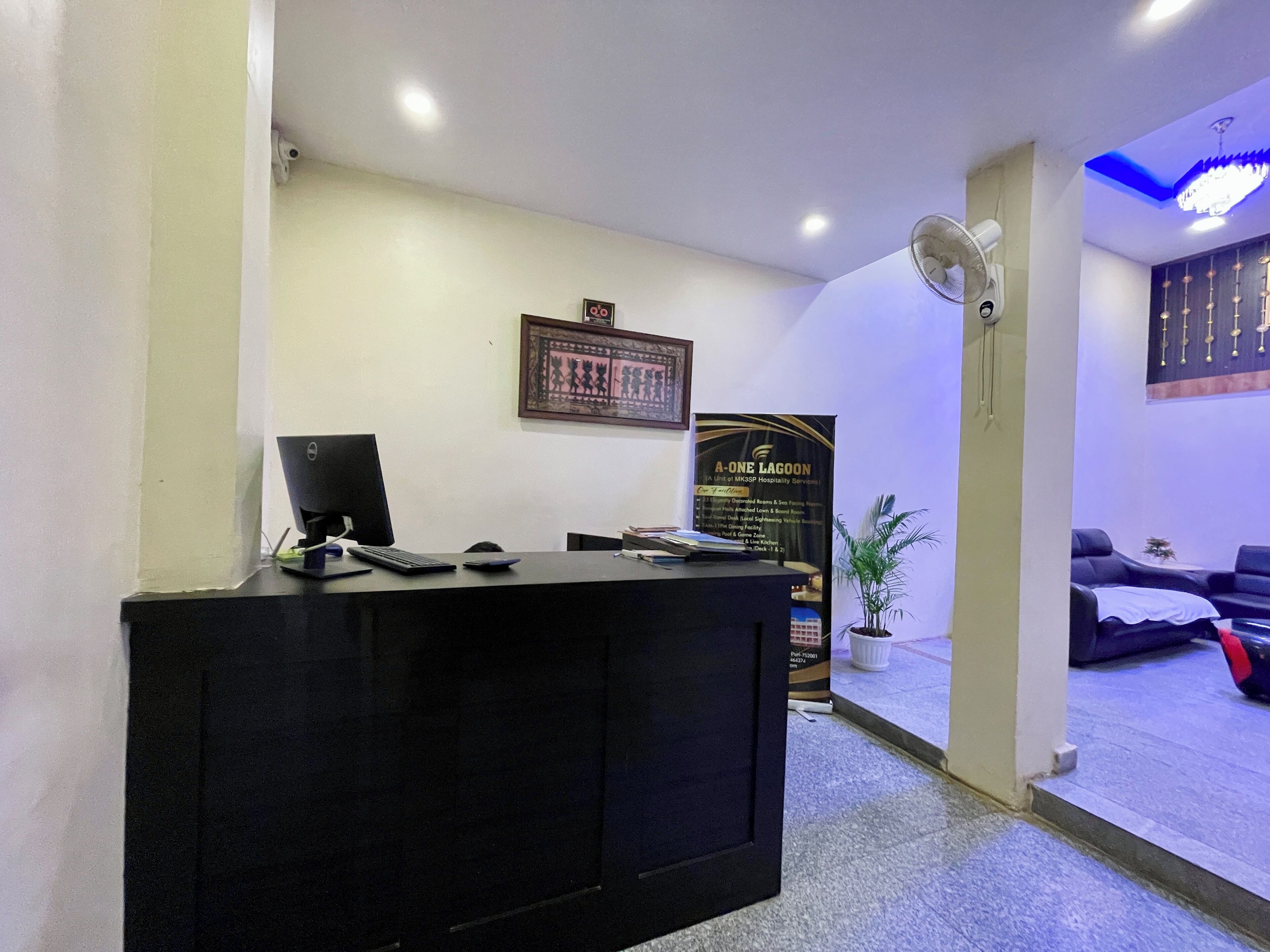 A reception area with a desk, computer, and a banner.