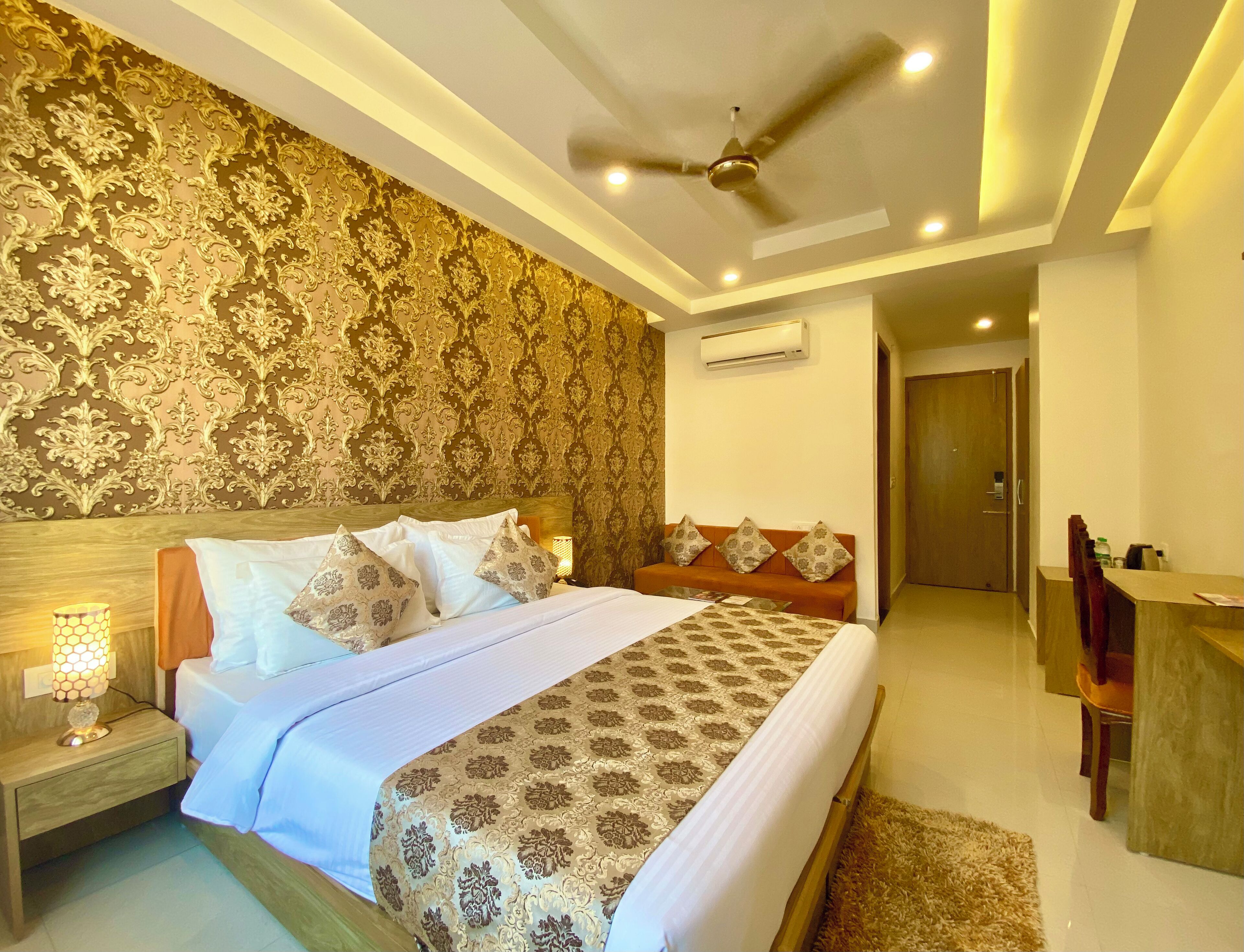 A well-lit bedroom with a bed, nightstand, and a ceiling fan.