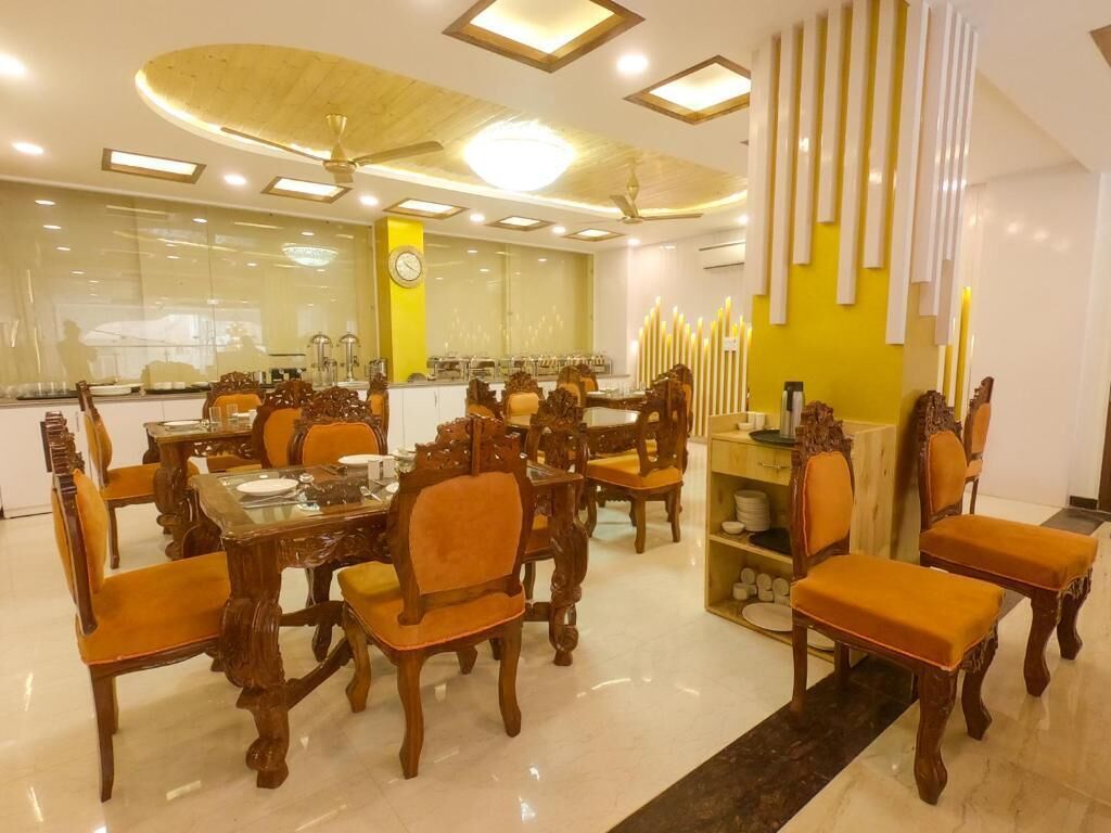 A dining area with wooden furniture and a yellow accent wall.