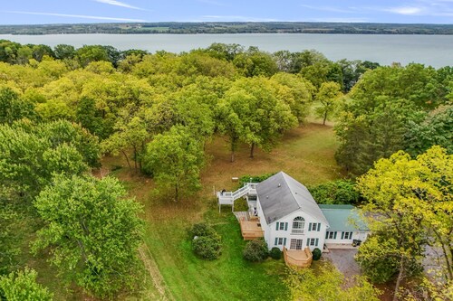 Nature-filled retreat with a private beach, kayaks, campfires, and easy access to Seneca Falls and the Cayuga Wine Trail.