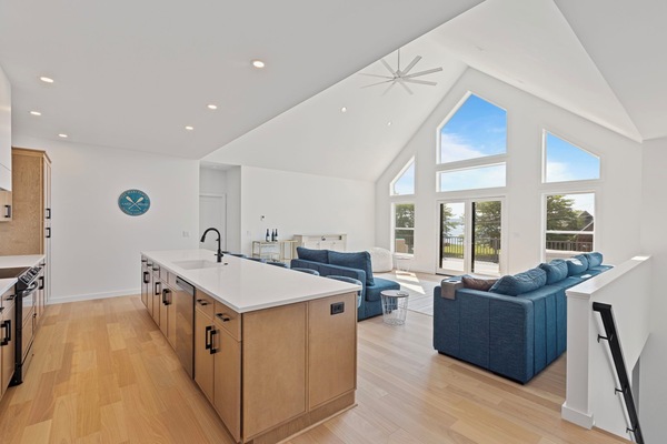 Soaring ceilings, sun-soaked windows, and seamless flow from kitchen to living room. Modern comfort meets lakeside elegance.