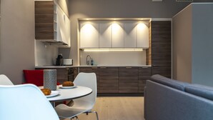 A modern kitchen with built-in cabinets, a central island, and under-cabinet lighting. - Forenom Serviced Apartments Bergen City (Bergen)