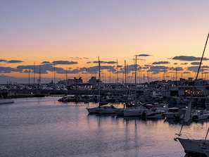 A marina at sunset with multiple boats docked. - Sanders Triple Limassol (Limassol)