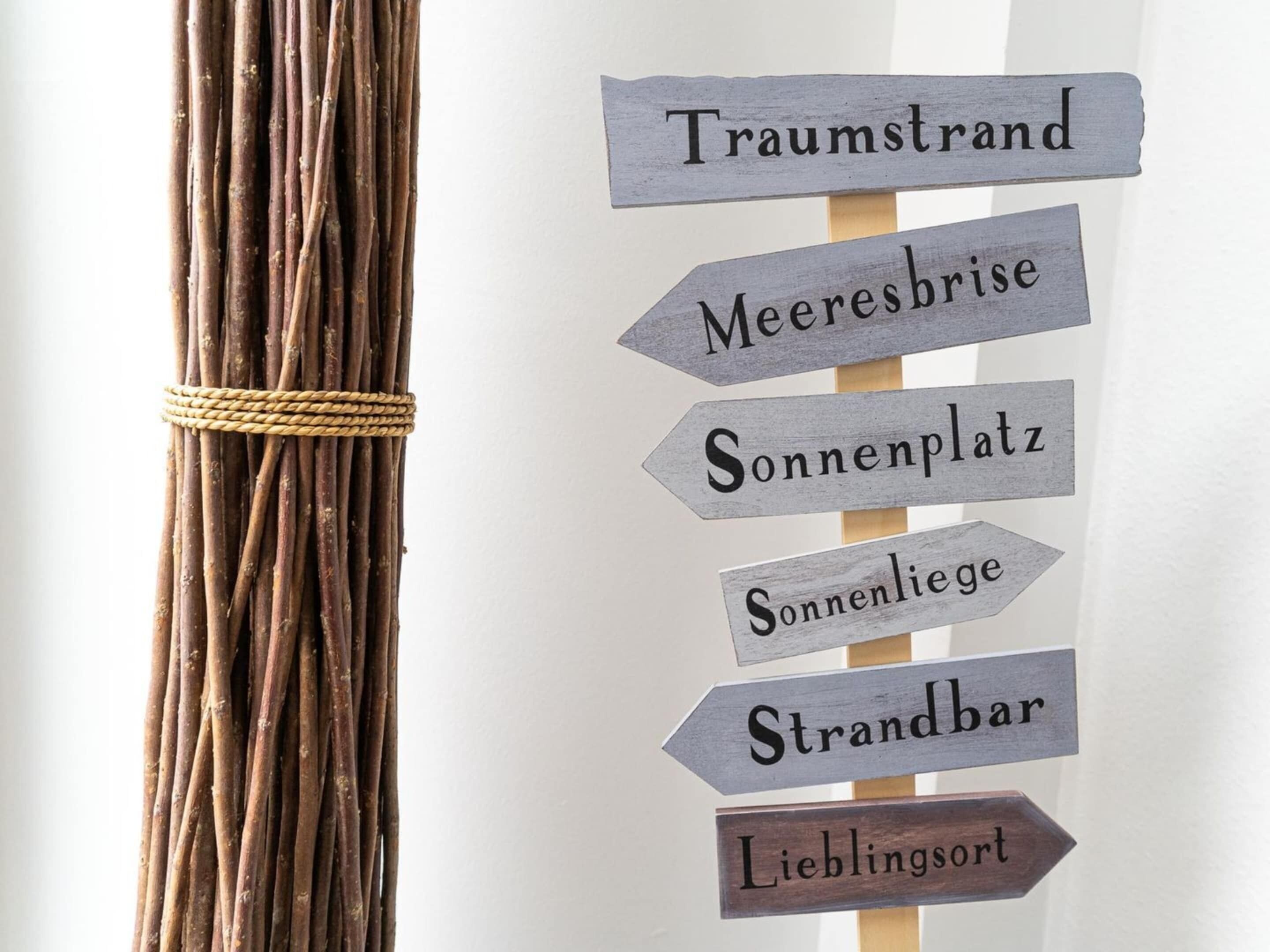 A directional sign with multiple arrows pointing to different locations.