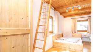 A wooden room with a bunk bed, a ladder, and a window. - Holiday Home in Strass With Mountain Views (Strass im Zillertal)