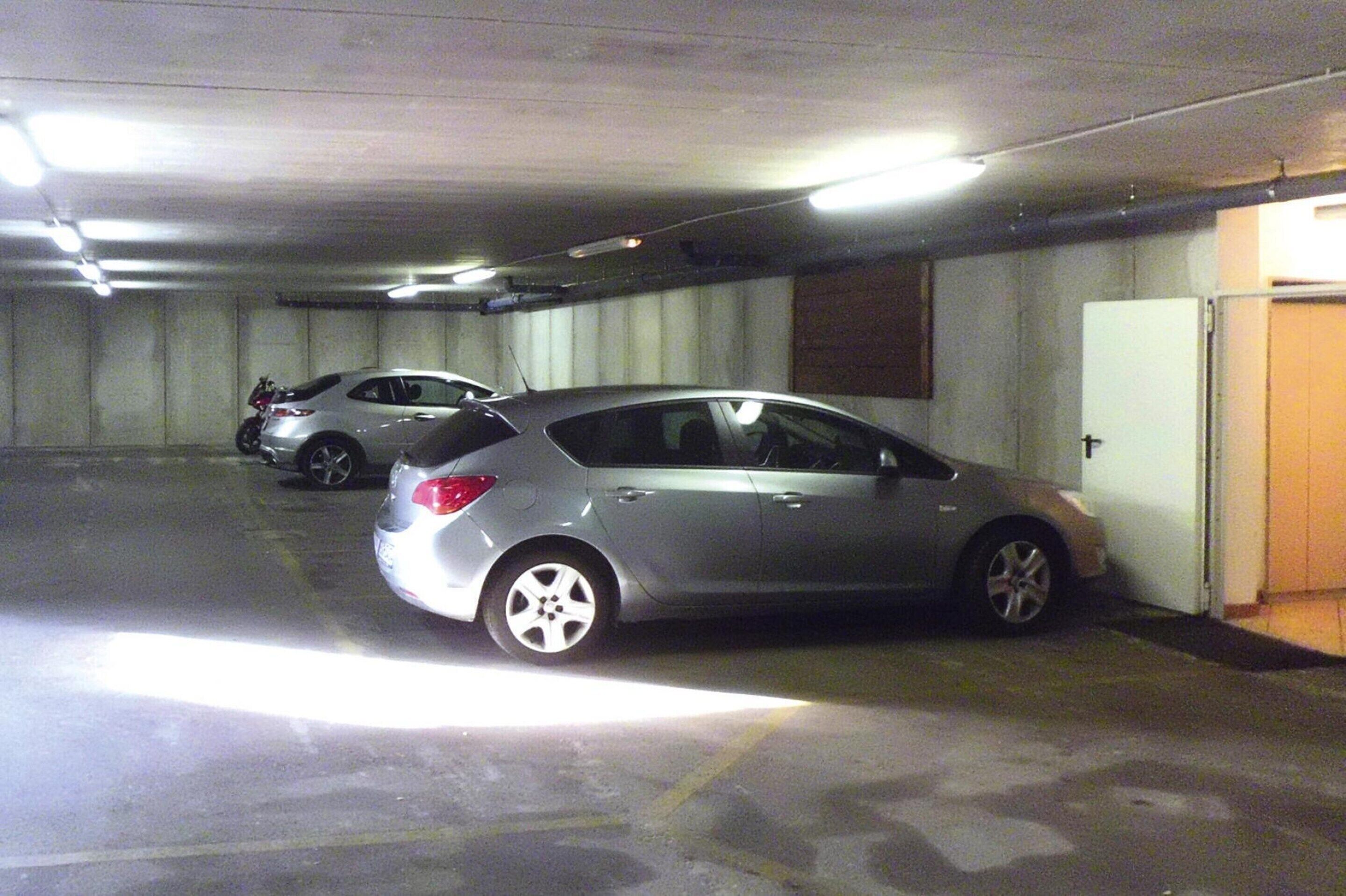 Un parking où deux voitures sont garées l'une à côté de l'autre.