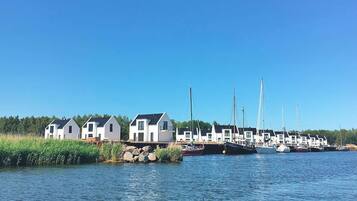 A marina with several white houses and sailboats docked.